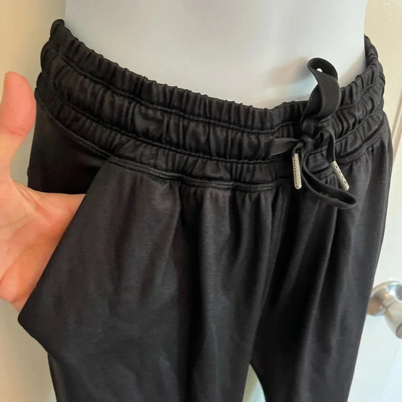 Lululemon black joggers with drawstring elastic waist band, and hemline. Size 4 - Picture 3 of 13